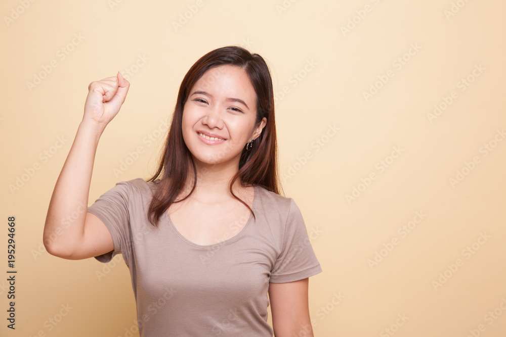 Successful young Asian woman hold fist up. Successful young Asian woman hold fist up.