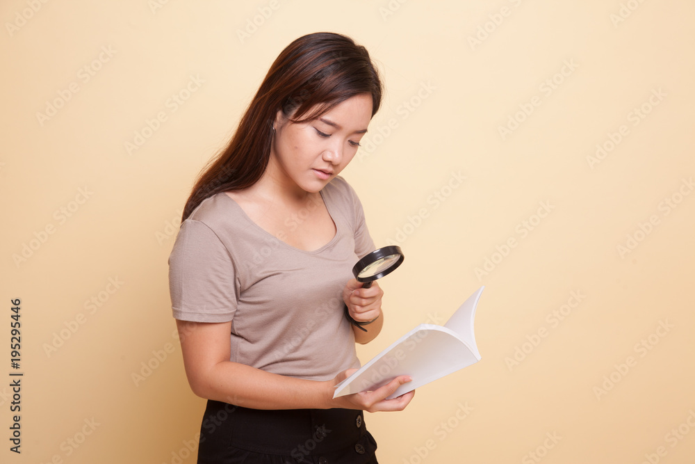 Asian woman with a book and magnifying glass. Asian woman with a book and magnifying glass.