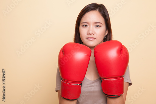 Young Asian woman with red boxing gloves.