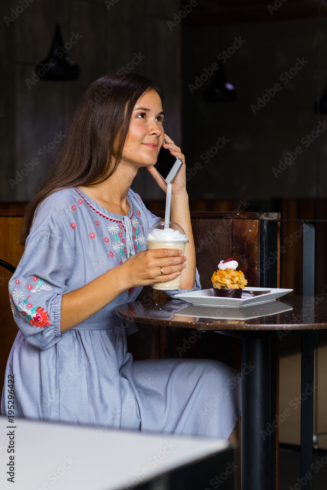 Woman talking with friends by mobile phone in cafe Woman talking with friends by mobile phone in cafe