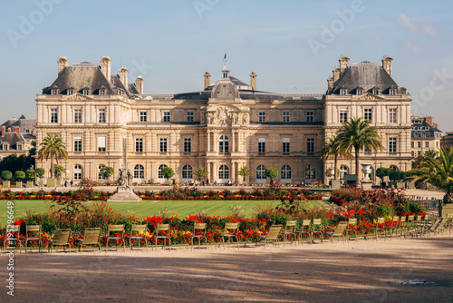 Luxembourg Gardens with yellow flowers, green grass, sculptures, chairs. photo