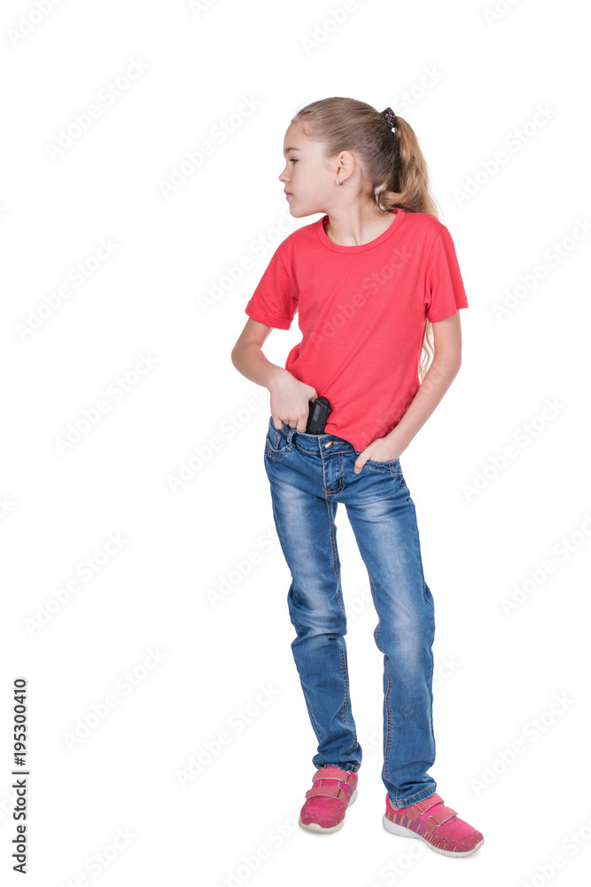 Fototapeta premium Portrait of a young girl looking sideways with a gun behind her belt isolated on white background