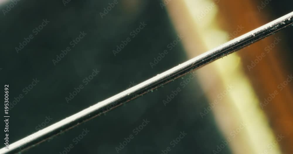 Macro shot of a guitar string, gears
on a guitar fret board. 4K. Micro.
Macro shot of a guitar string, gears
on a guitar fret board. 4K. Micro.