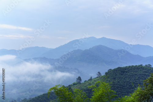Beautiful green mountains covering by fog at Phu Huai Isan in the morning , Nong Khai , Thailand