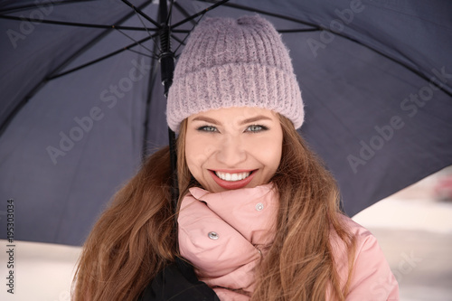 Young woman with black umbr...