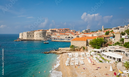 Dubrovnik, Croatia - September 26, 2012: View to Dubrovnik old town and sandy beach Banje from North. Copy space in sky. photo