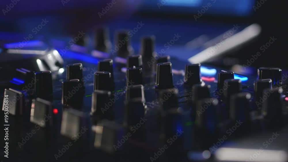 DJ hands turning knobs on professional DJ mixer console DJ hands turning knobs on professional DJ mixer console