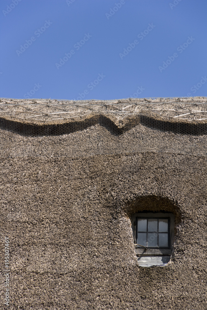 Semi-abstract thatched roof and window Semi-abstract thatched roof and window