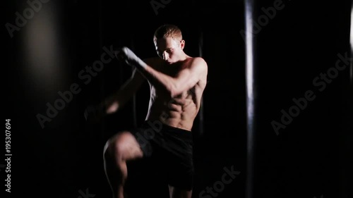 Young man punches in boxing gym. shadow boxing.