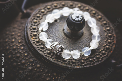 Crystal quartz bracelet on romantic background