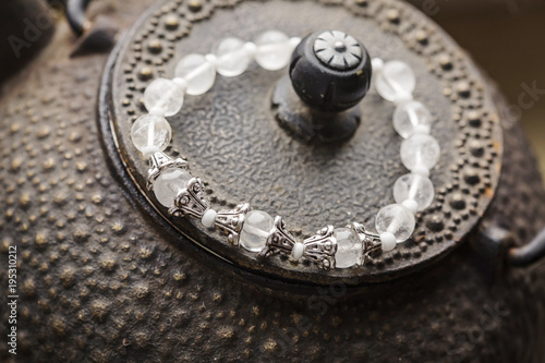 Crystal quartz bracelet on romantic background