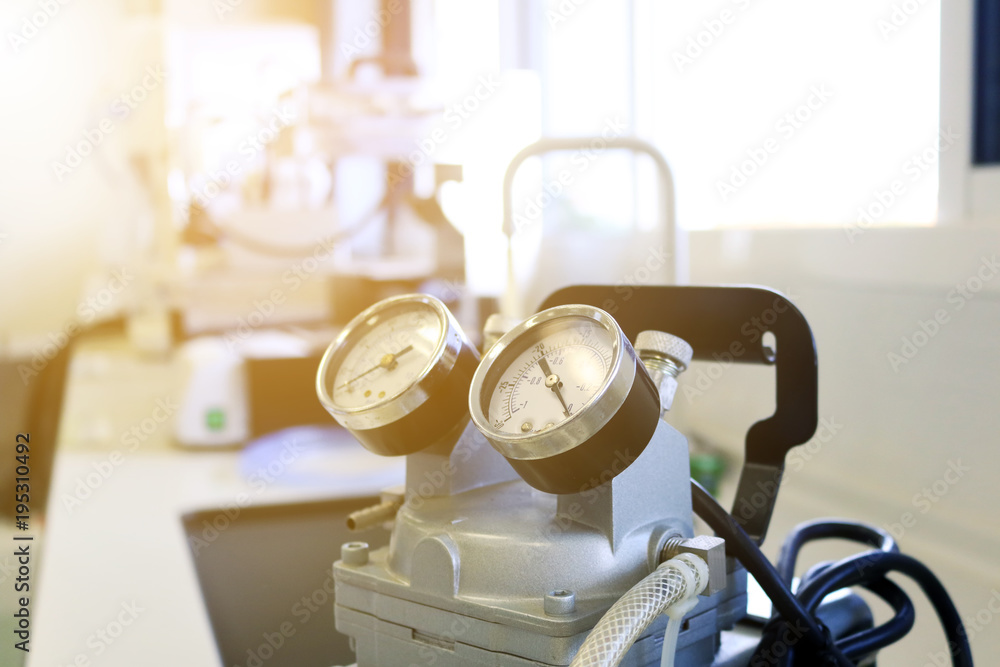 Fototapeta premium Close up pressure gauge on the air compressor use for scientific experimental. Chemical air pump used for filtrate reagents in laboratory. 