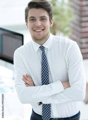 confident young businessman on background of office