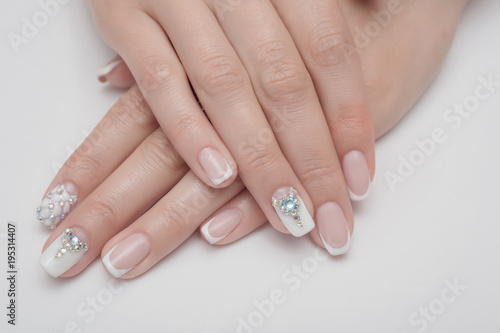 Light manicure in light on a white background.