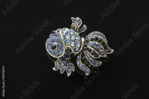 brooch fish with diamonds isolated on black
