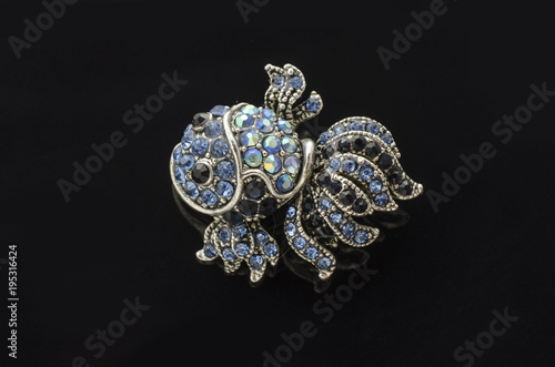 brooch fish with diamonds isolated on black © vitaly tiagunov