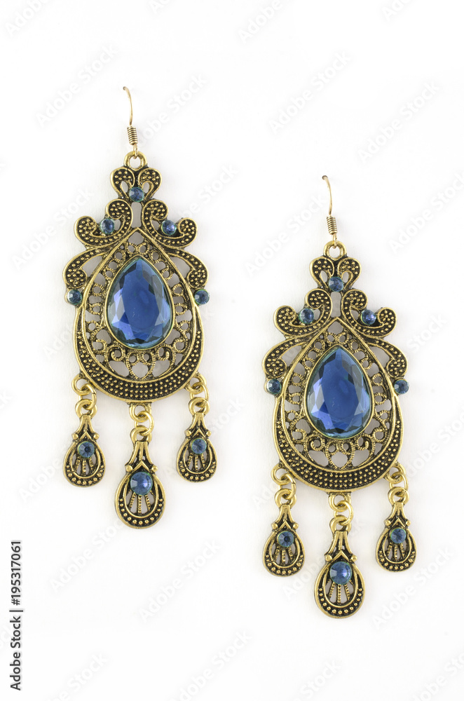 gold earrings with blue stones isolated on white