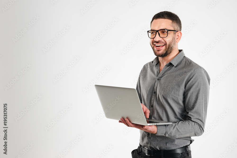 Laughing businessman using laptop computer. Laughing businessman using laptop computer.
