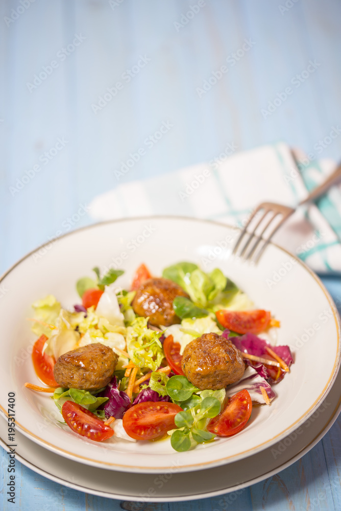 Colorful fresh vegetable salad with meatballs