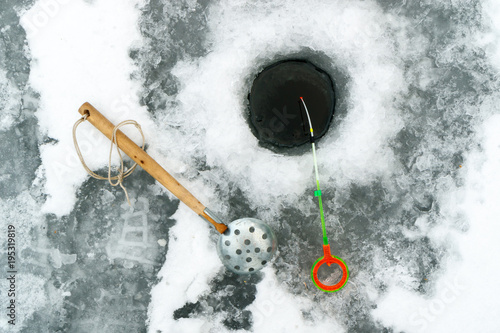 winter accessories for fishing top view near the holes, ice and tackle