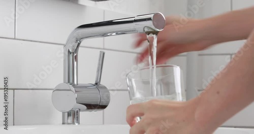 Filling glass of mains water, drinking water close-up