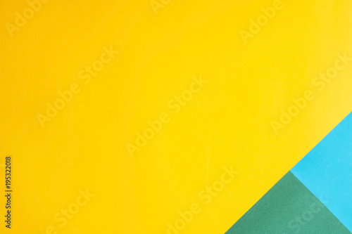 Combined multicolored decorative background. The main color is yellow and additional - green and blue. Copyspace, flat lay, top view