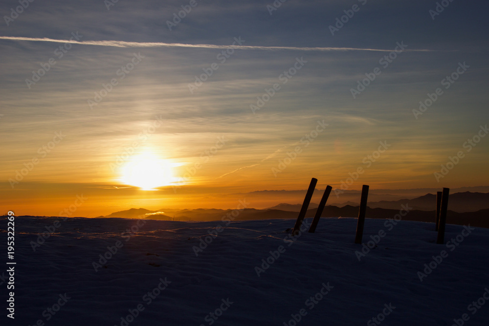 beautiful sunset on the top of ligurian mountains in winter