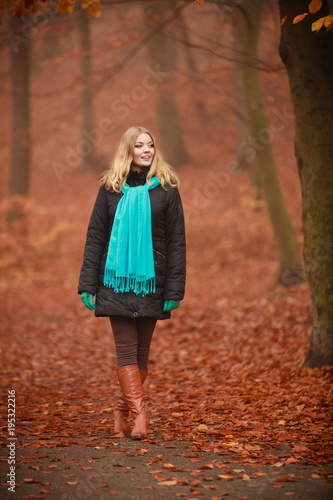 Attractive woman in autumnal park.