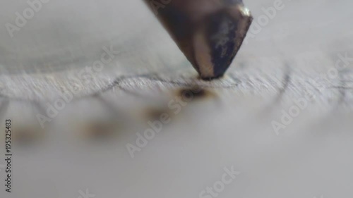 Pyrograph burning with a point pattern on wood photo