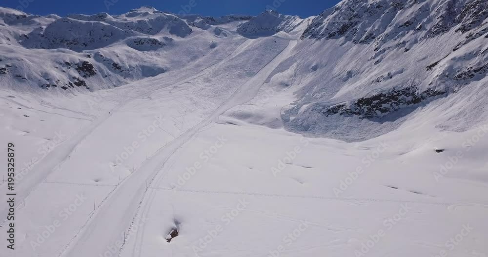 Cinematic aerial shot of the pistes on a beautiful Swiss alpine landscape Cinematic aerial shot of the pistes on a beautiful Swiss alpine landscape