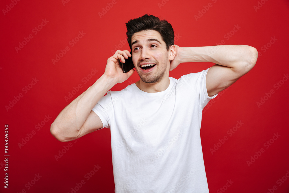 Portrait of a smiling young man in white t-shirt talking Portrait of a smiling young man in white t-shirt talking