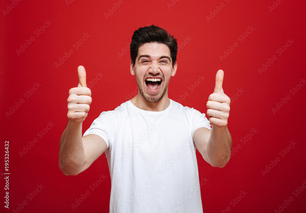 Portrait of a joyful young man in white t-shirt Portrait of a joyful young man in white t-shirt
