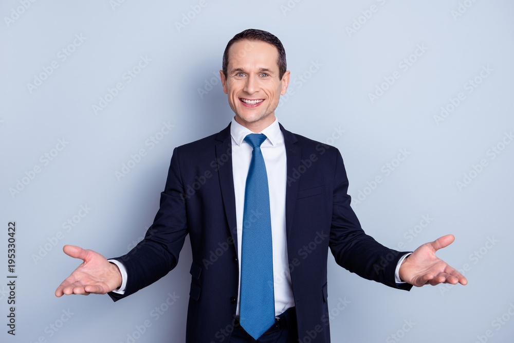 Cheerful, nice man in formal wear with tie having his hands open like hospitable gesture, you are welcome, well met, standing over gray background Cheerful, nice man in formal wear with tie having his hands open like hospitable gesture, you are welcome, well met, standing over gray background