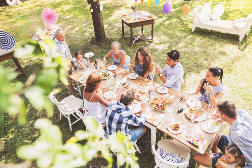 Family celebration or a garden party outside in the backyard. photo