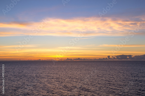 Sunrise on a Caribbean Cruise-  Beautiful orange and pink sunrise over the Ocean 