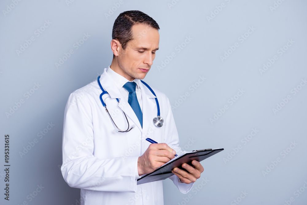 Medicare wellness wellbeing therapy remedy treatment lab intern control notes people person read concept. Half-turned portrait of qualified professional serious confident doc isolated gray background Medicare wellness wellbeing therapy remedy treatment lab intern control notes people person read concept. Half-turned portrait of qualified professional serious confident doc isolated gray background