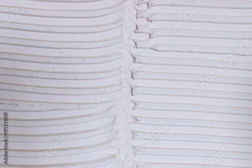 Fotografi Tile adhesive notched trowel patterns. Adhesive background.