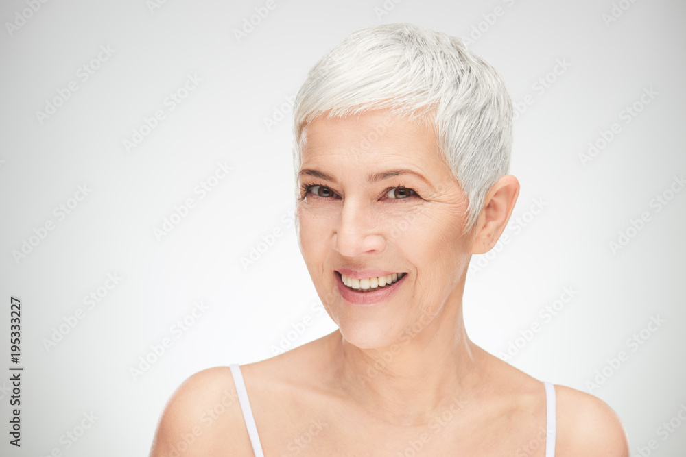 Portrait of beautiful senior woman in front of white background. Portrait of beautiful senior woman in front of white background.