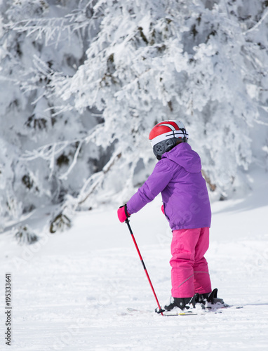 Child skiing on mountain peak