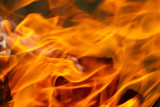 Fire, red and orange texture on a black background. blurry