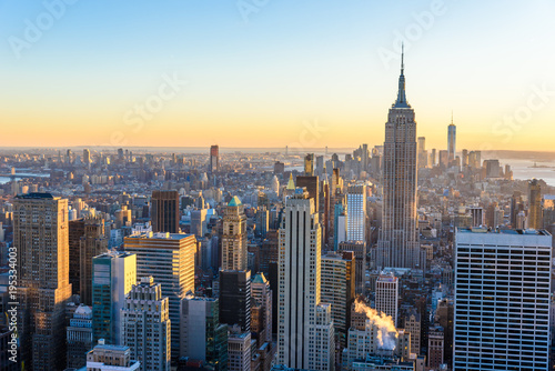 New York City - USA. View to Lower Manhattan downtown skyline with famous Empire State Building and skyscrapers at sunset.