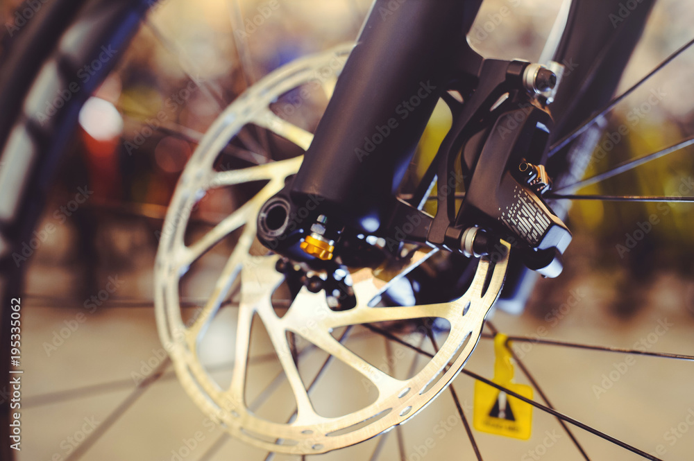 Fototapeta premium Mountain bike front wheel with mechanical disc marriage. Part of Mountain Bike brake in close up