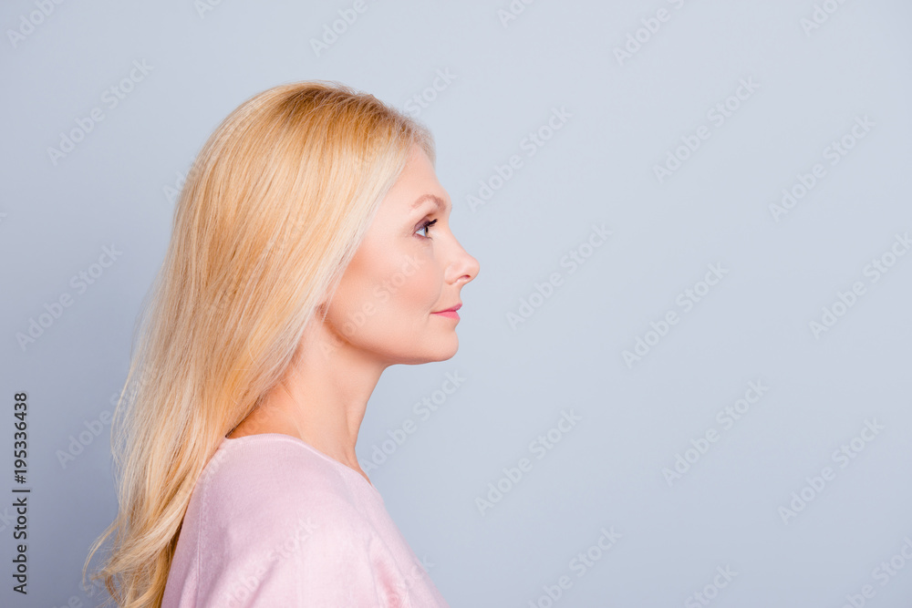 Half-face close up portrait of confident serious focused attractive stunning gorgeous mature lady with long smooth soft healthy hair looking aside isolated on gray background copy-space Half-face close up portrait of confident serious focused attractive stunning gorgeous mature lady with long smooth soft healthy hair looking aside isolated on gray background copy-space