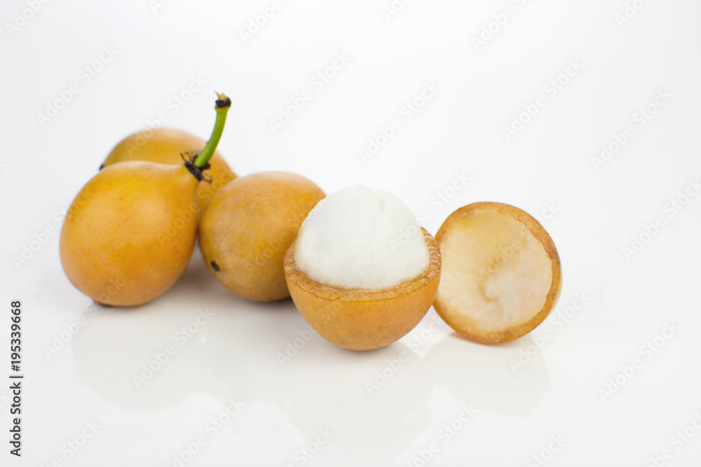 Open Bolivian exotic fruit called Achachairu in white background