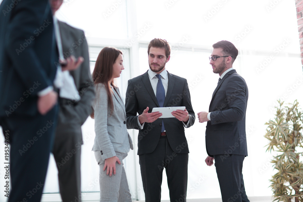 Happy business colleagues in modern office using tablet Happy business colleagues in modern office using tablet