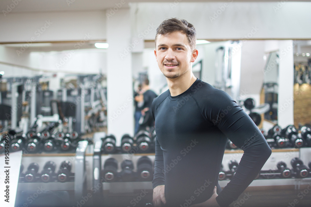 Portrait of handsome young man in sportswear at gym. Portrait of handsome young man in sportswear at gym.
