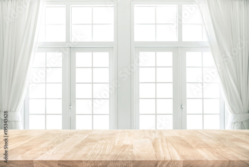 Wood table top on blur of white window with curtain background