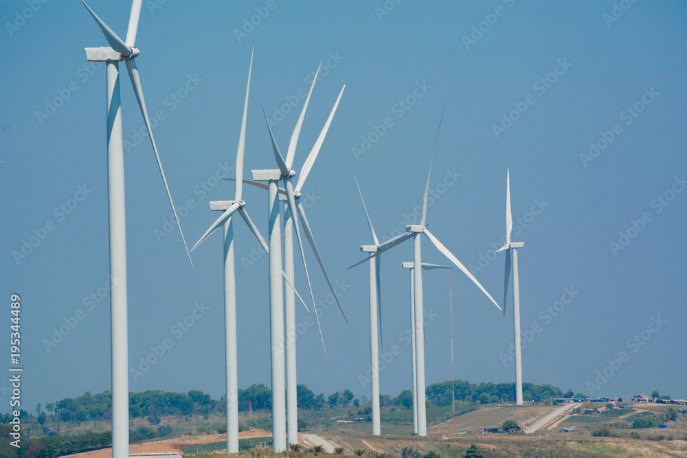Wind turbines under the blue sky. Wind turbines generating electricity. Wind turbines under the blue sky. Wind turbines generating electricity.