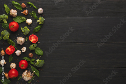 Border of fresh vegetables on wooden background