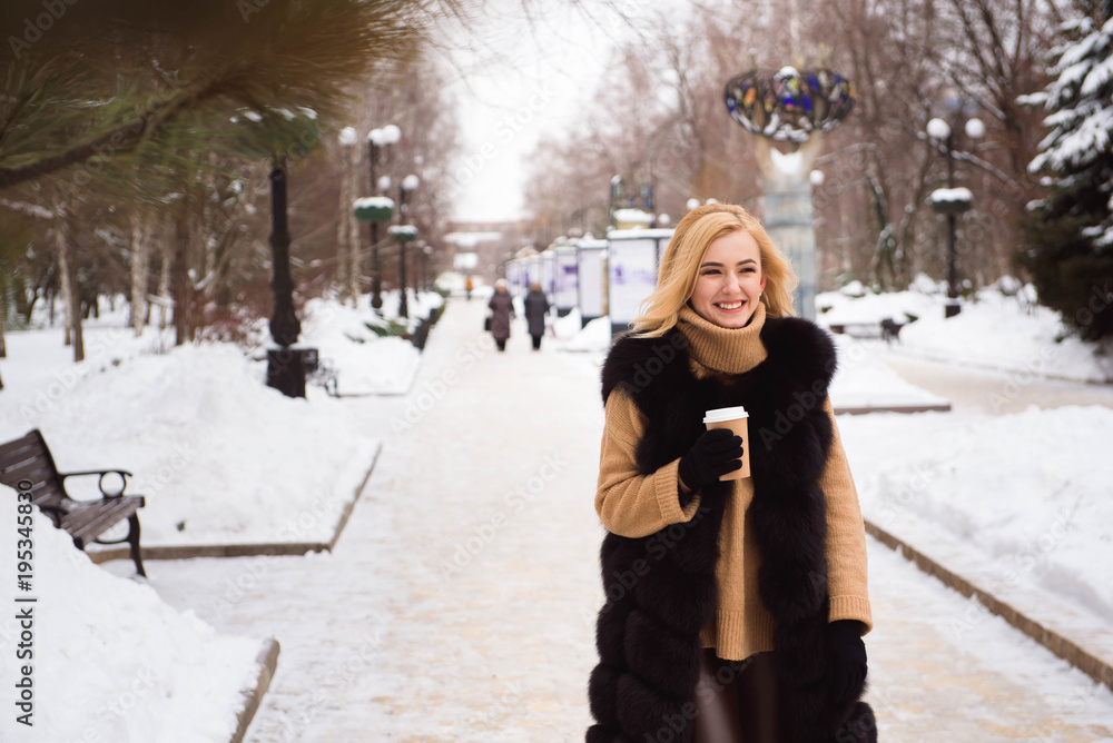 Outdoor close up photo of young beautiful happy smiling girl walking on street in winter. Outdoor close up photo of young beautiful happy smiling girl walking on street in winter.